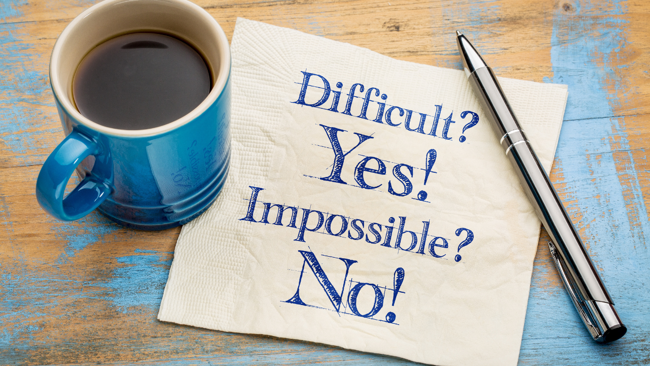 cup of coffee with a note saying: Difficult? Yes! Impossible? No!