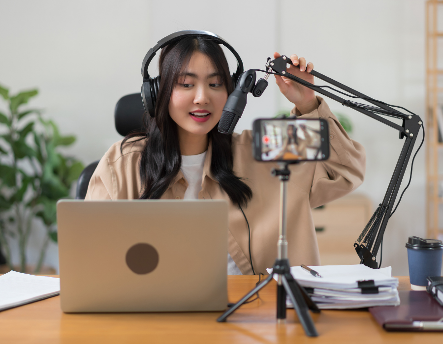 Female podcaster using microphone